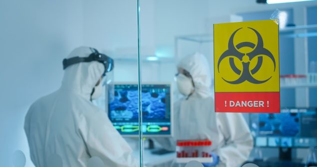 worried-scientists-ppe-suit-talking-glass-wall-working-danger-area-lab_482257-536